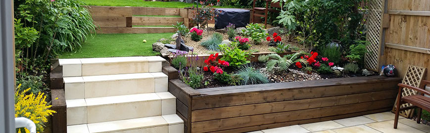 Joseph Mat Landscape, featheredge fence and trellis,  sandstone paving, sleepers raised beds, garden bench, turf, gravel area and path